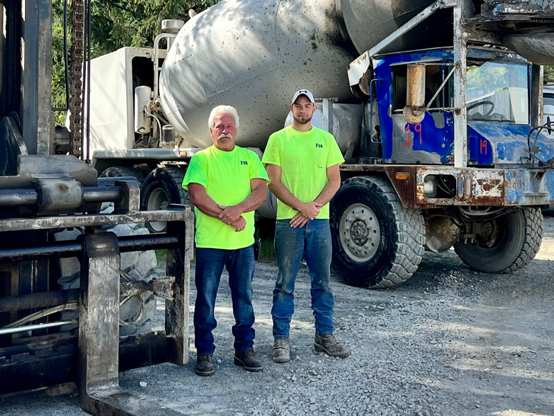 fort miller employees standing in front of construction vehicles