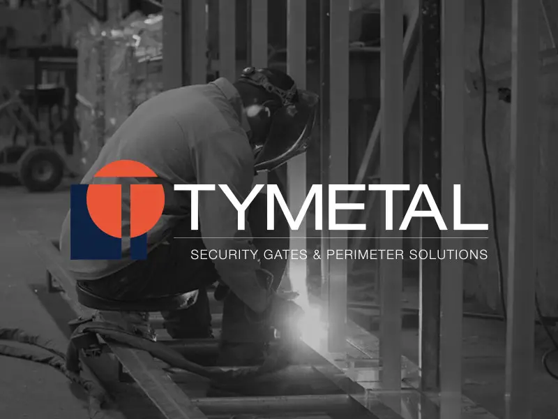 man welding metal in warehouse